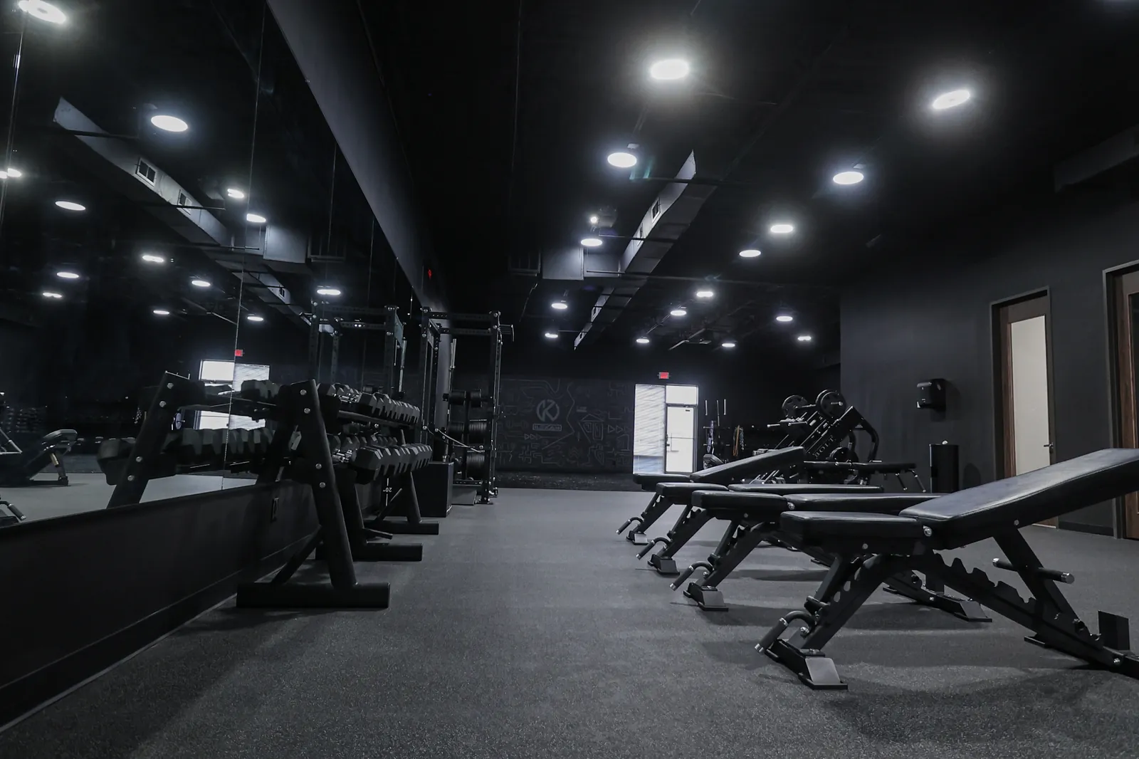 Benches and racks lined up across the darkened club floor