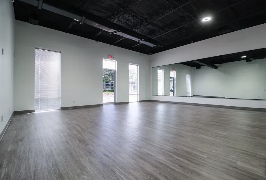 The open floor of the rental studio with vinyl flooring