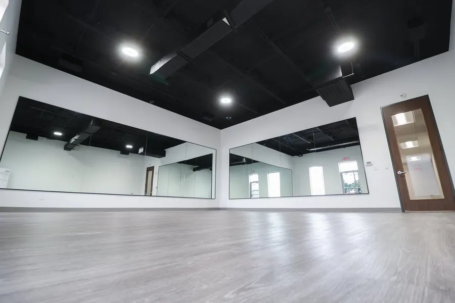 Wide view of the studio showing lighting and mirrored wall